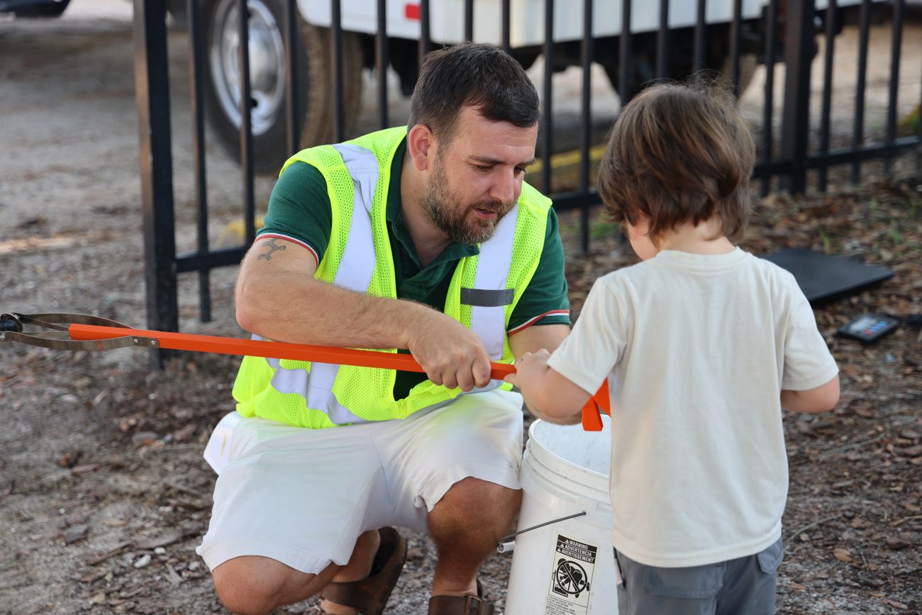 Chris Bellingham and his son picking up litter at a Deltona lake cleanup